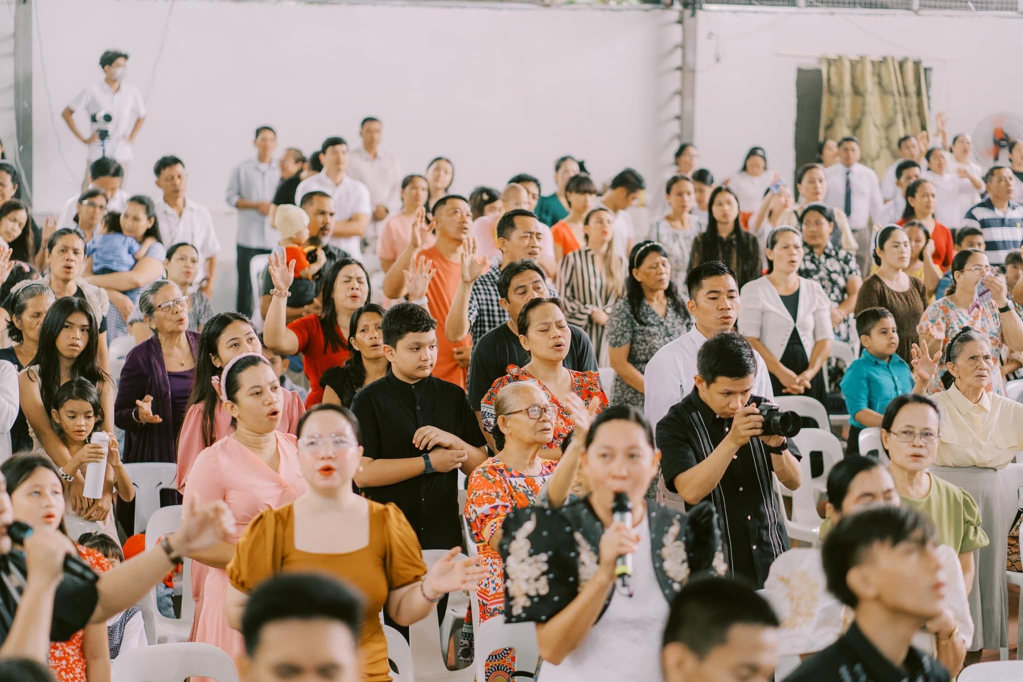 The congregation raising hands in worship