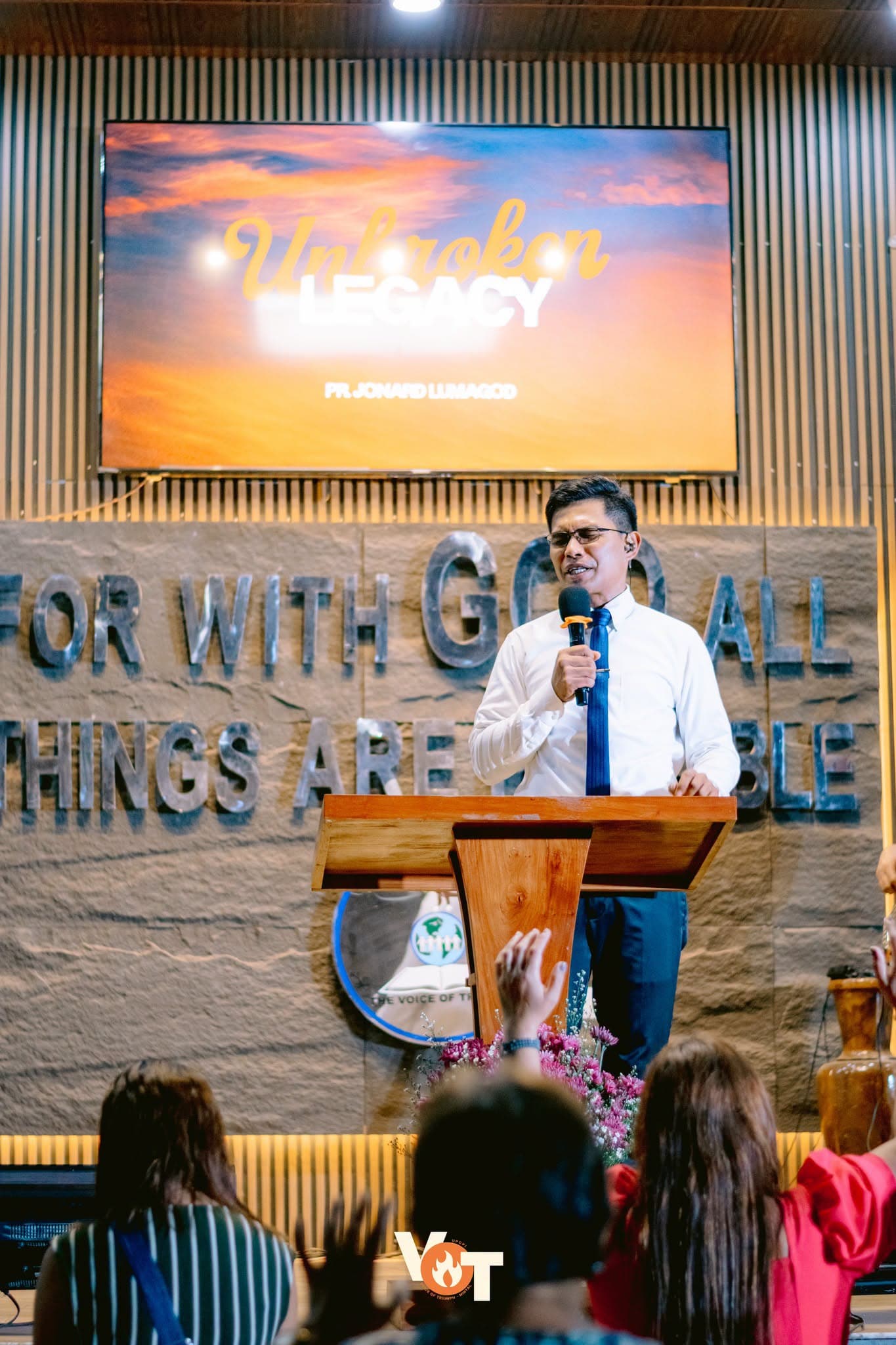 Pastor Jonard Lumagod preaching "Unbroken Legacy" at the pulpit
